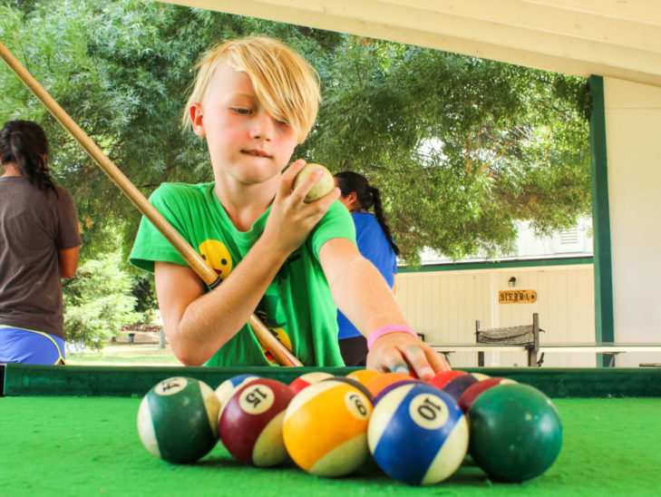 A camper setting up for a game of billiards.