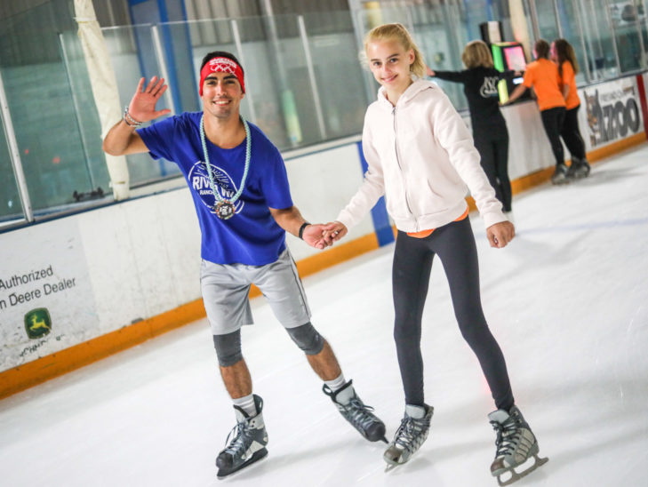 A camper learning how to ice skate.