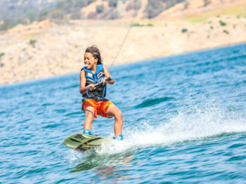 A camper having fun while wakeboarding.
