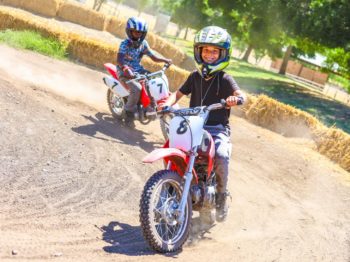 Campers riding on a course on mini bikes.