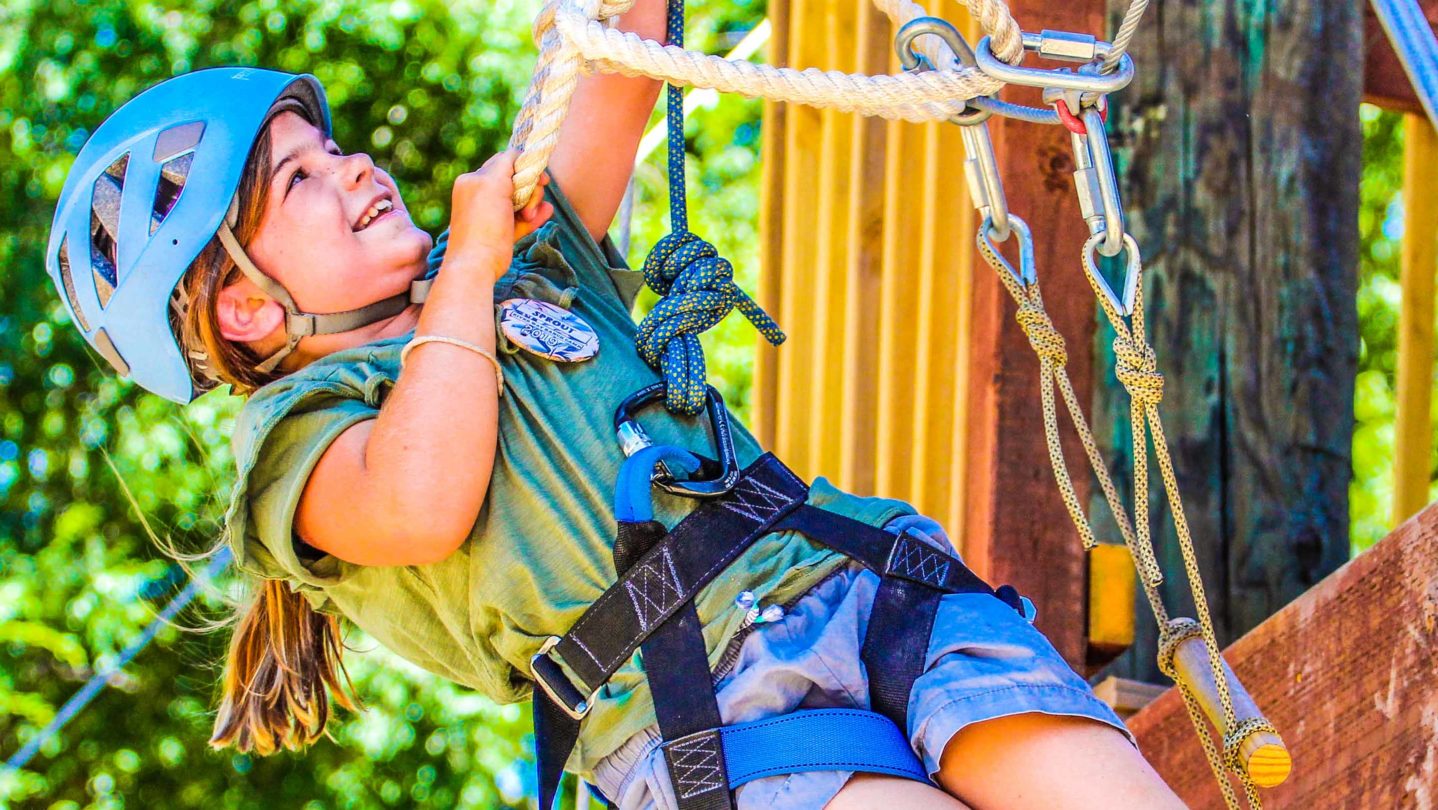 A camper on a ropes course