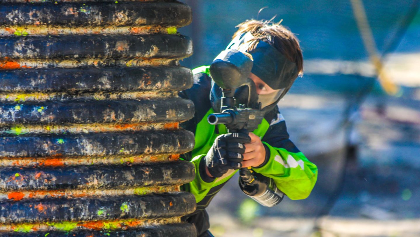 A camper shooting paintball