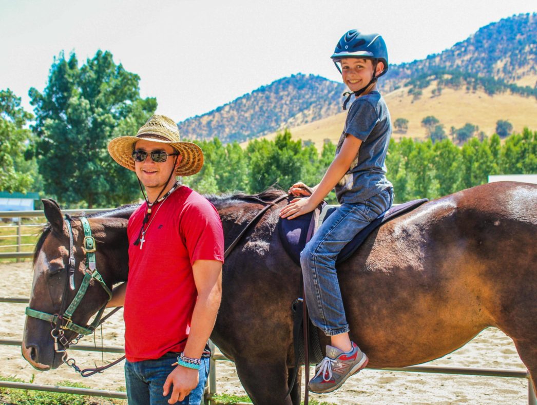 A camper learning how to ride a horse